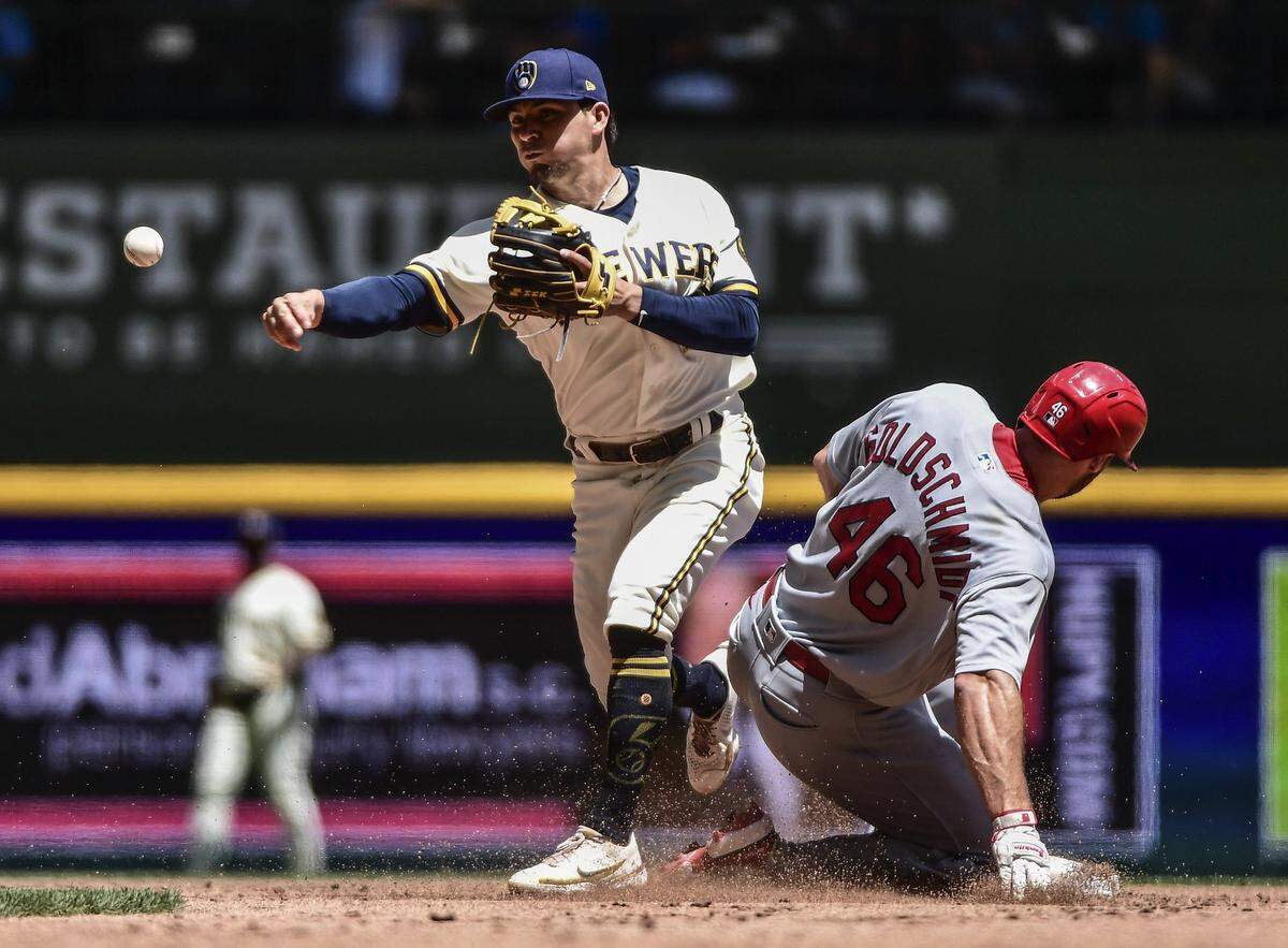 Jun 23, 2022; Milwaukee, Wisconsin, USA;  Milwaukee Brewers second baseman Luis Arias (2) completes a double play after forcing out St. Louis Cardinals first baseman Paul Goldschmidt (46) in the third inning at American Family Field. Mandatory Credit: Benny Sieu-USA TODAY Sports