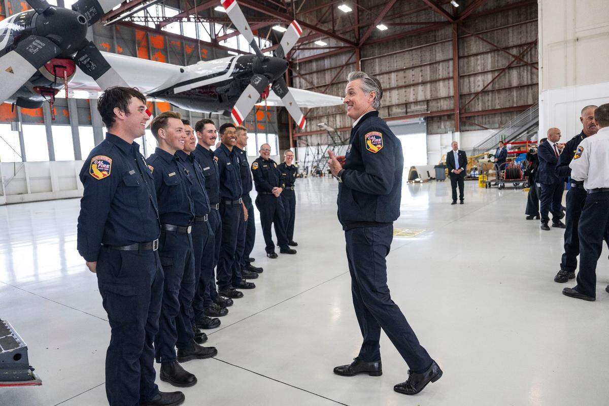 Gov. Gavin Newsom thanks Cal Fire staff for their work after he talked about the state’s new C-130H firefighting airplane during a press conference at McClellan Park in April.