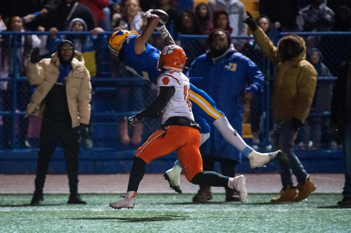 Grant Pacers receiver Kingston Lopa (2) makes the catch over San Jacinto Tigers cornerback Hajani Washington (14) to score a touchdown during the second half of the 2022 CIF State Football Division III-AA Championship on Saturday, Dec. 10, 2022, at Grant High School in Sacramento. The Pacers won 36-34.