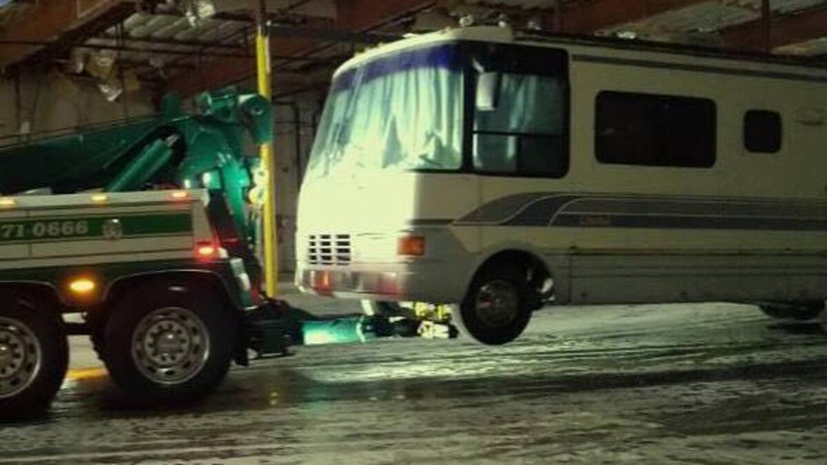 West Sacramento police tow a stolen motor home from a warehouse where they found four stolen vehicles on Wednesday.