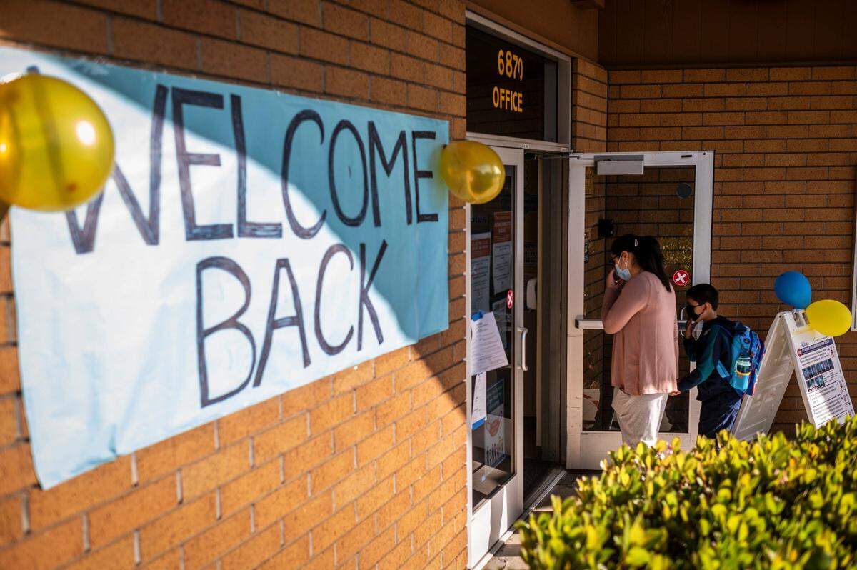Students walk into school before the first bell at Caroline Wenzel Elementary in Sacramento on Thursday, April 8, 2021.