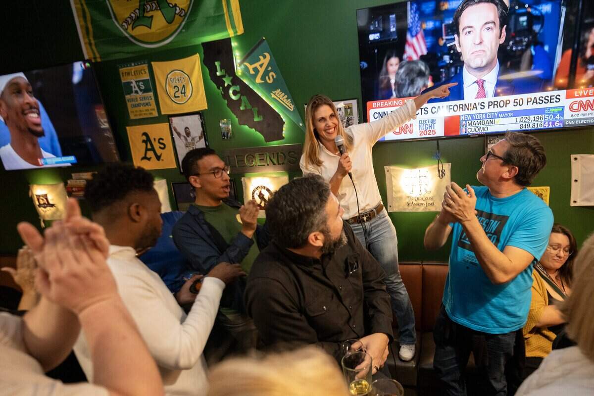 Assemblymember Maggy Krell, D-Sacramento, points to the Proposition 50 results while hosting an election night party at Mojo’s Local Tap & Kitchen in Sacramento.
