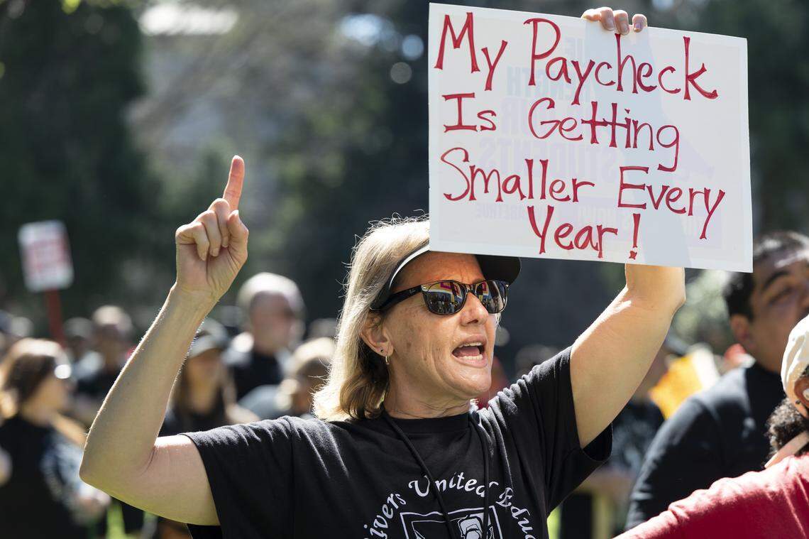 Kelli Springer, a fourth grade teacher at Strauch Elementary, attends a rally held by the Natomas Teachers Association and Twin Rivers United Educators in Sacramento on Thursday as a part of their strikes against their respective districts.