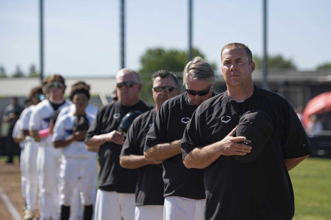 Franklin Wildcats coach Bryan Kilby, right, stands during the national anthem before a game against Pleasant Grove at Franklin High School in Elk Grove in 2023. On Friday, the school’s activities director and longtime baseball coach earned his 300th career varsity victory.