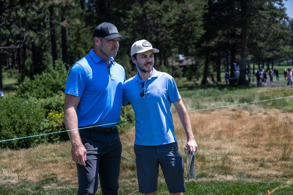 Hall of Fame Chicago Bear linebacker Brian Urlacher stands for a photo with fan Brendan Howard of South Lake Tahoe during the final day of the American Century Championship celebrity golf tournament at Edgewood Tahoe Resort in Stateline, Nev., on Sunday, July 13, 2025.