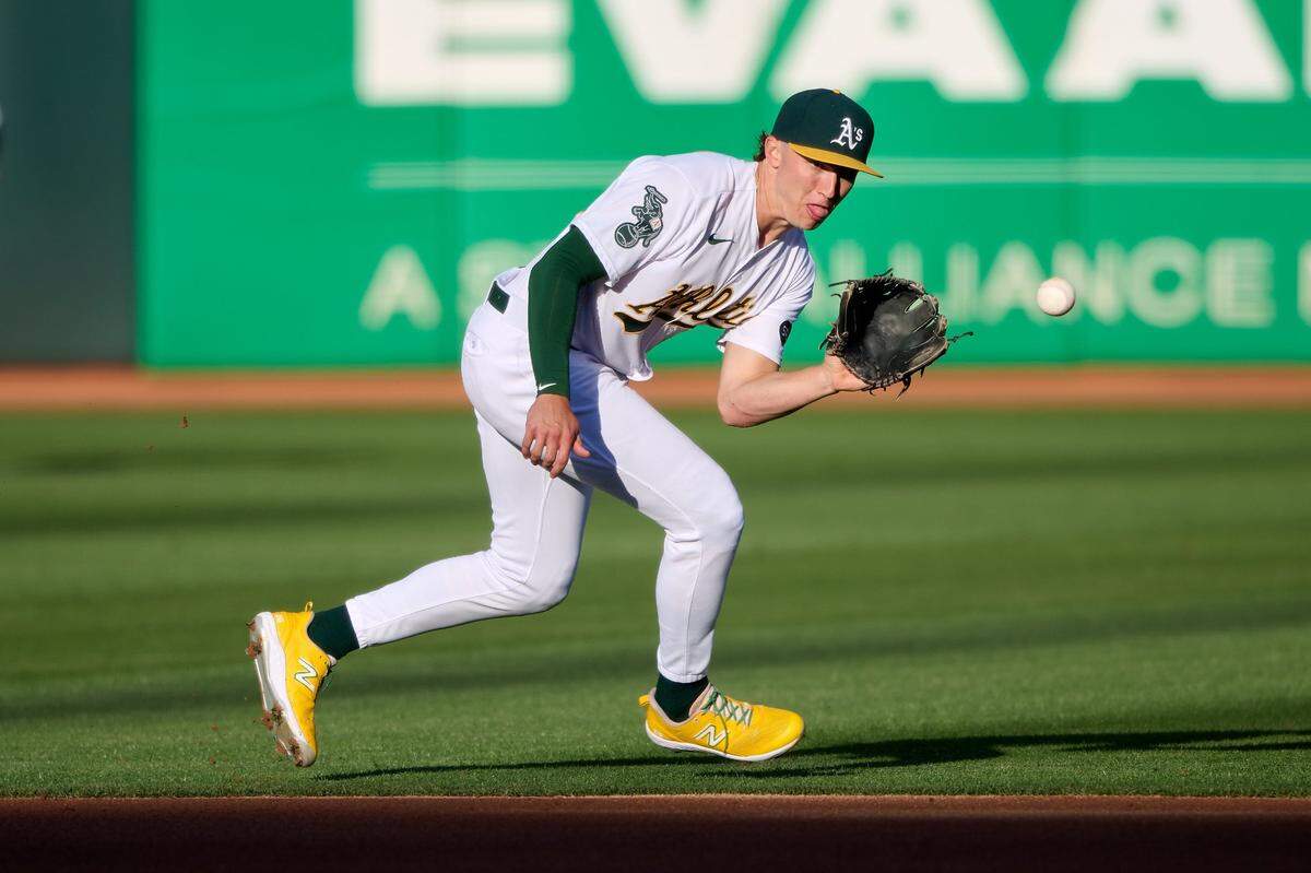 Oakland Athletics infielder Zack Gelof (20) fields a ground ball against the Texas Rangers during the first inning Aug. 7, 2023, at Oakland-Alameda County Coliseum.