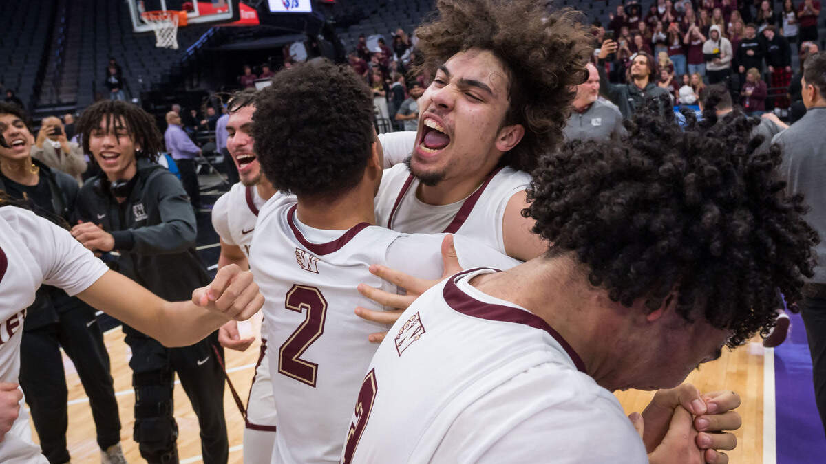 Whitney Wildcats guard Elijah Samdahl (14), right, hugs guard Jadon Hurtado (2) as teammates celebrate their win overt the Granite Bay Grizzlies at the CIF Sac-Joaquin Section Division II high school boys basketball final game Friday, Feb. 24, 2023, at Golden 1 Center in Sacramento.