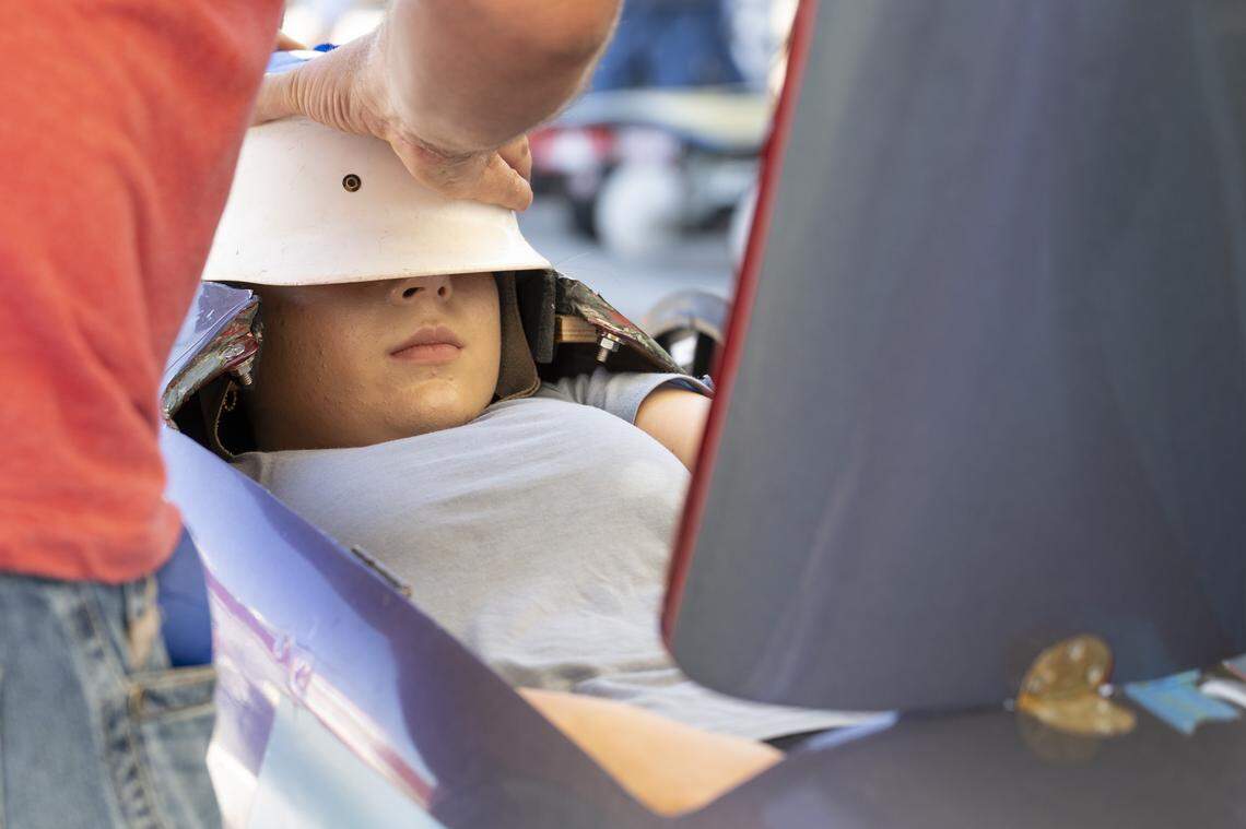A racer is fitted into her car during a masters class race in the Folsom Historic District’s All-American Soap Box Derby in Folsom on Sunday, Oct. 5, 2025.