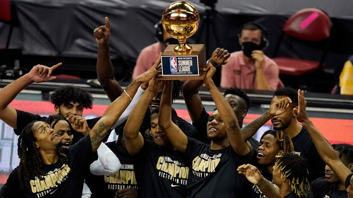 Sacramento Kings players hold up the trophy after defeating the Boston Celtics in the NBA summer league championship basketball game Tuesday, Aug. 17, 2021, in Las Vegas. (AP Photo/John Locher)