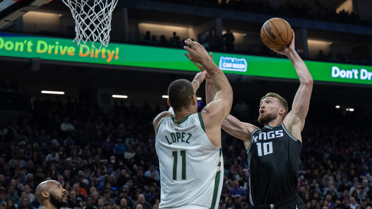 Sacramento Kings forward Domantas Sabonis (10) goes over Milwaukee Bucks center Brook Lopez (11) for a basket in the second quarter during a game at Golden 1 Center in Sacramento, Monday, March 13, 2023.
