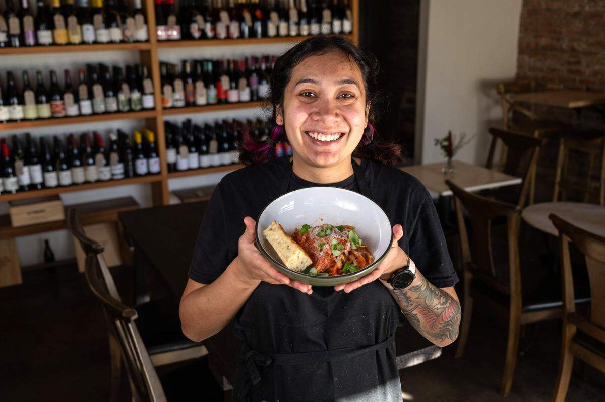 Chef/general manager Amanda Smith holds a plate of Nonna’s pasta at Betty Wine Bar & Bottle Shop in Sacramento’s Southside Park neighborhood earlier this month.