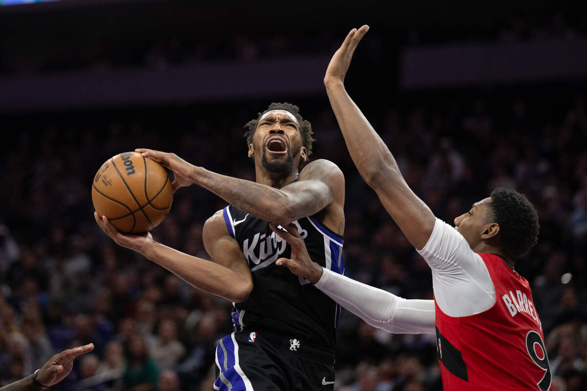 Toronto Raptors guard RJ Barrett (9) defends Sacramento Kings guard Malik Monk (0) as he drives to the basket in the second half in an NBA game on Wednesday, Nov. 6, 2024 at Golden 1 Center.