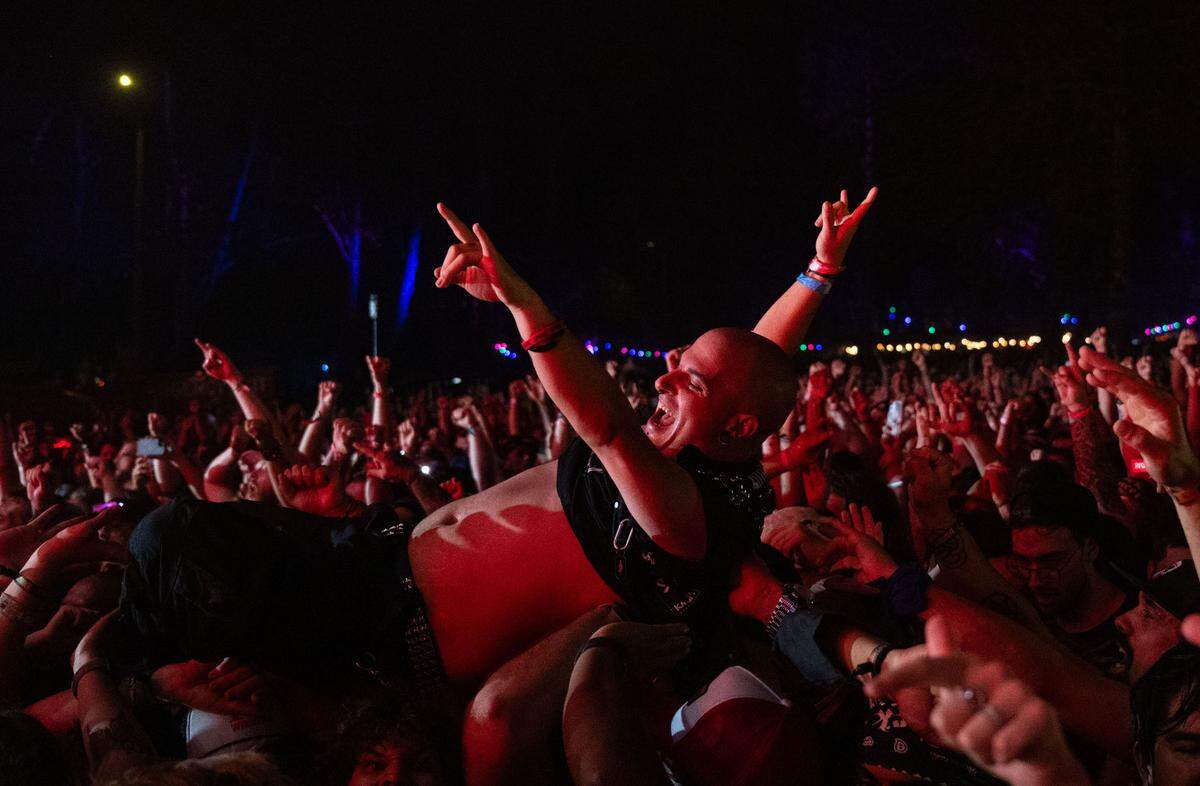 A man crowdsurfs during the Disturbed’s set at the Aftershock festival in Sacramento’s Discovery Park on Sunday, Oct. 13, 2024. 