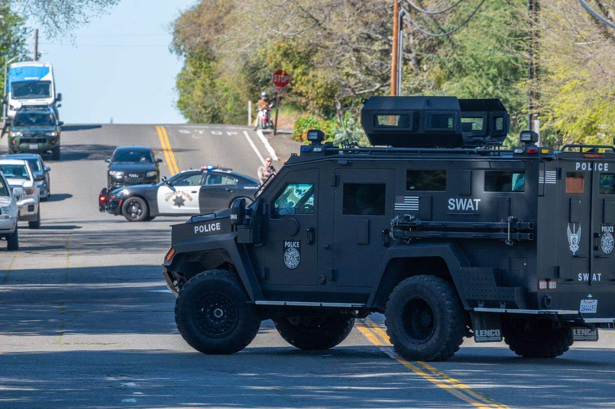 A Sacramento Police SWAT vehicle arrives on the scene after gunfire erupted at the Hazel Ranch apartment complex in the 8800 block of Winding Way in Fair Oaks on Friday.