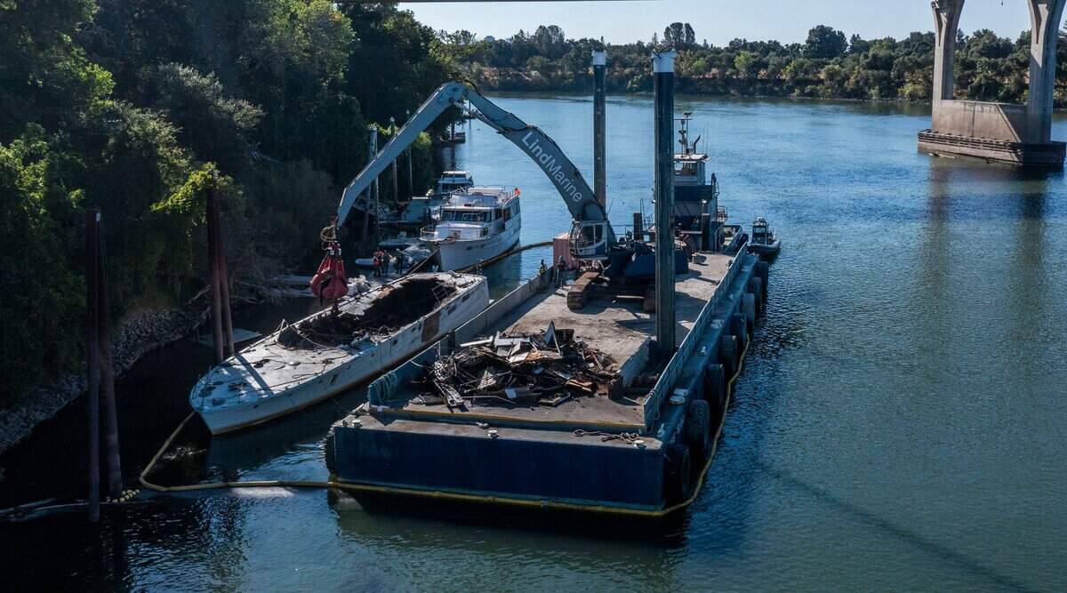 The “All American,” a derelict 85-foot, privately-owned vessel that caught fire in June on the Sacramento River, is removed from the water Wednesday. The boat was deconstructed on the water, piled onto a barge, and transported to the Lind Marine Shipyard in Vallejo for disposal.