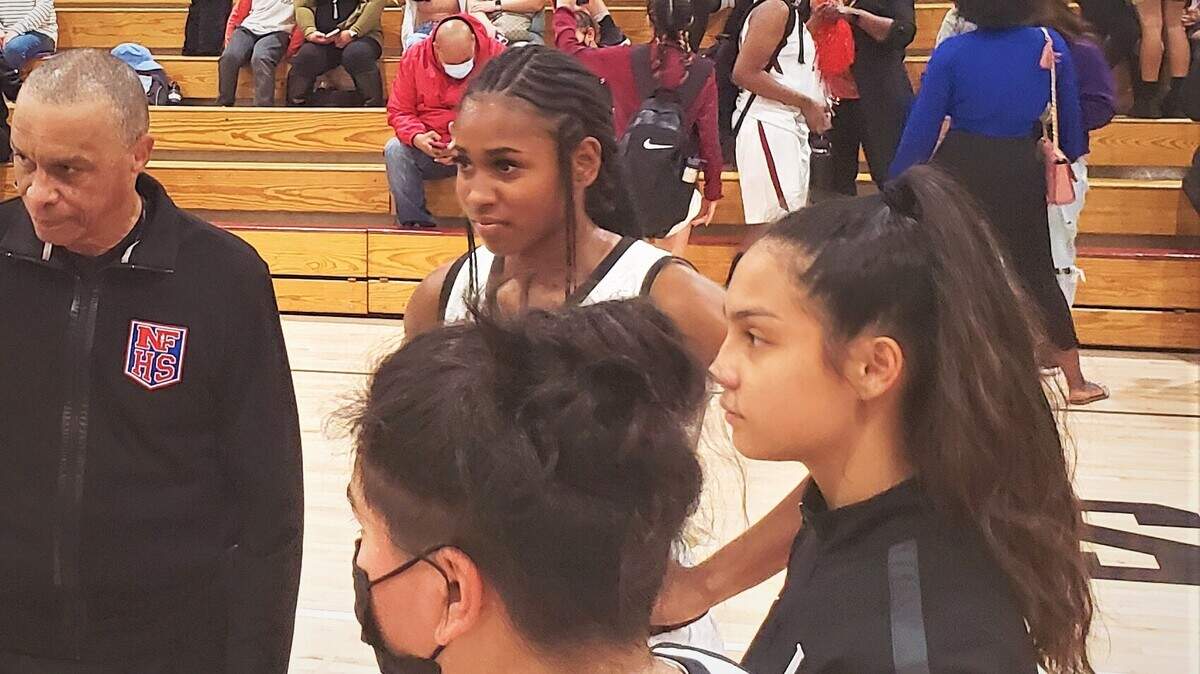 Laguna Creek seniors (clockwise from top) Ahrray Young, Zoe Tillery and Alicia Enriquez listen in on the captains’ meeting before Tuesday night’s game against Sheldon.