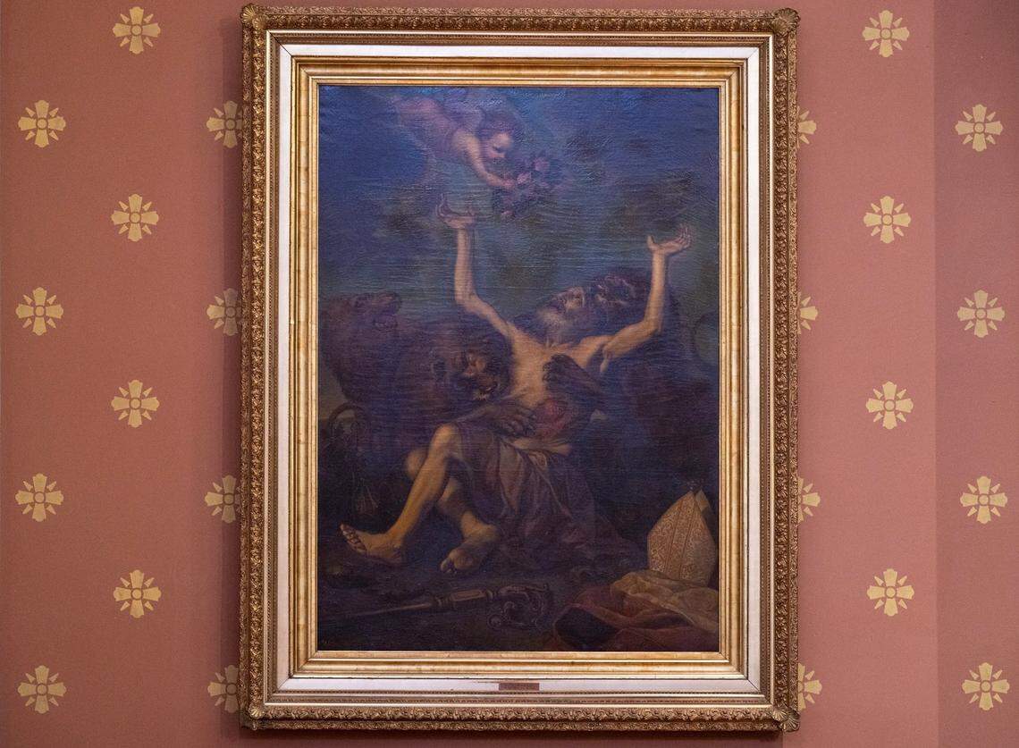 An image of a bishop being eaten alive by wild beasts with an angel arriving at the top of the frame to martyr him hangs east of the church organ at the Cathedral of the Blessed Sacrament in downtown Sacramento. A gift to the church by Bishop Manogue in 1889, its message is to be willing make any sacrifice for the flock.