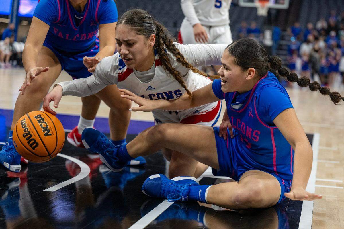 The Atwater Falcons’ Natalia Melgoza (11) and the Christian Brothers Falcons’ Leila Serrano (22) battle for a loose ball in the first half of the CIF Sac-Joaquin Section Division ll girls basketball championship game at Golden 1 Center on Thursday, Feb. 27, 2025.