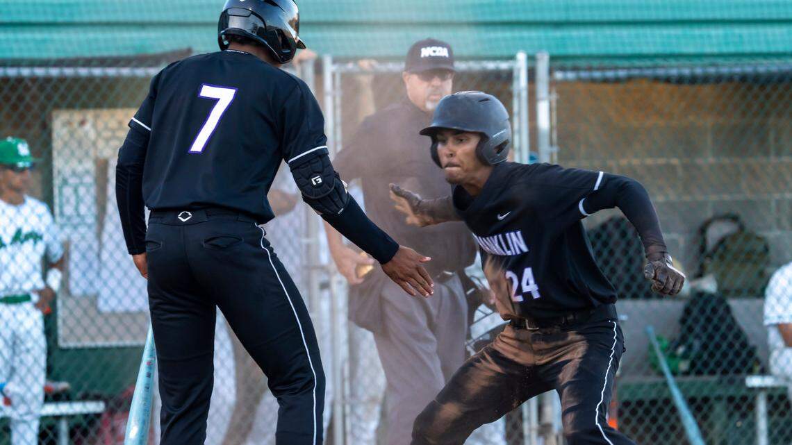 The Franklin High School Wildcats’ Jason Harris celebrates his score with Dylan Minnatee during a four-run inning in the 2025 CIF Sac-Joaquin Section Division I baseball championship game at Sacramento City College against the St. Mary’s Rams of Stockton.
