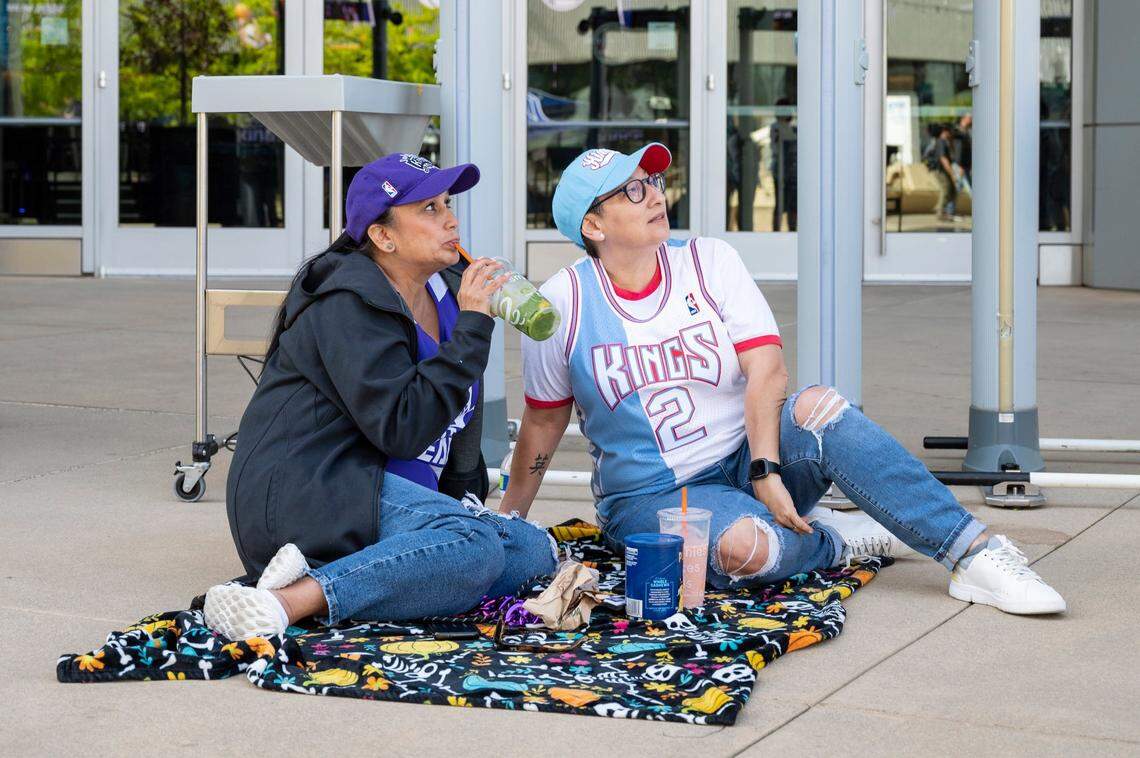 Roxanne Tyler, left, of Sacramento, and Isela Saavedra claim their spot, since 8:40 a.m., to be first to enter the Game 4 watch party at Golden 1 Center on Sunday.