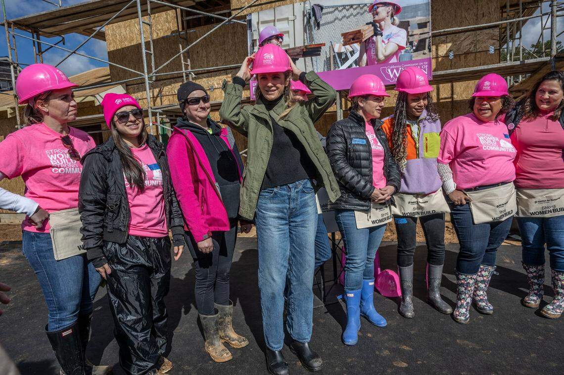 First Partner Jennifer Siebel Newsom adjusts her hard hat during a Habitat for Humanity event to celebrate International Women’s Day in Sacramento on Wednesday. “For us to lend a hand today, its something that I love more than anything, its about service. Service connects us, it reminds us to look beyond ourselves to that which binds to our common humanity,” she said.