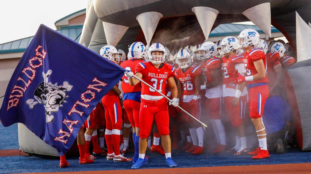Former Folsom football player Dylan Richard (31) carries a flag before the teams game against De La Salle last Sept. He will be transported to Craig Hospital this week after suffering a TBI injury in May.