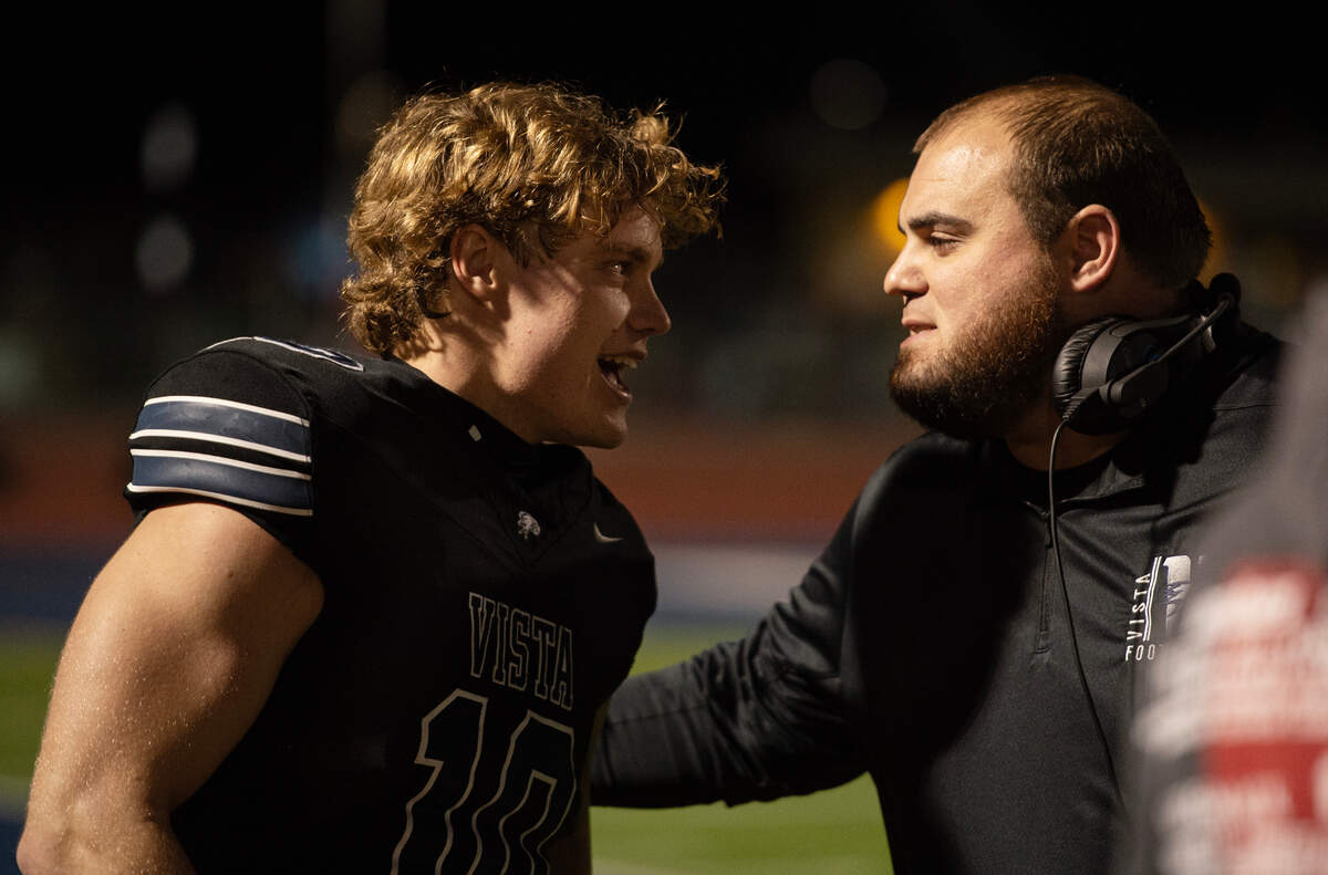 Vista del Lago Eagles receiver Matt Long (10) checks in with coach Kyle Landes before the start of their CIF Sac-Joaquin Section playoff quarterfinal against Rio Americano on Friday in Folsom. Long had three touchdowns.