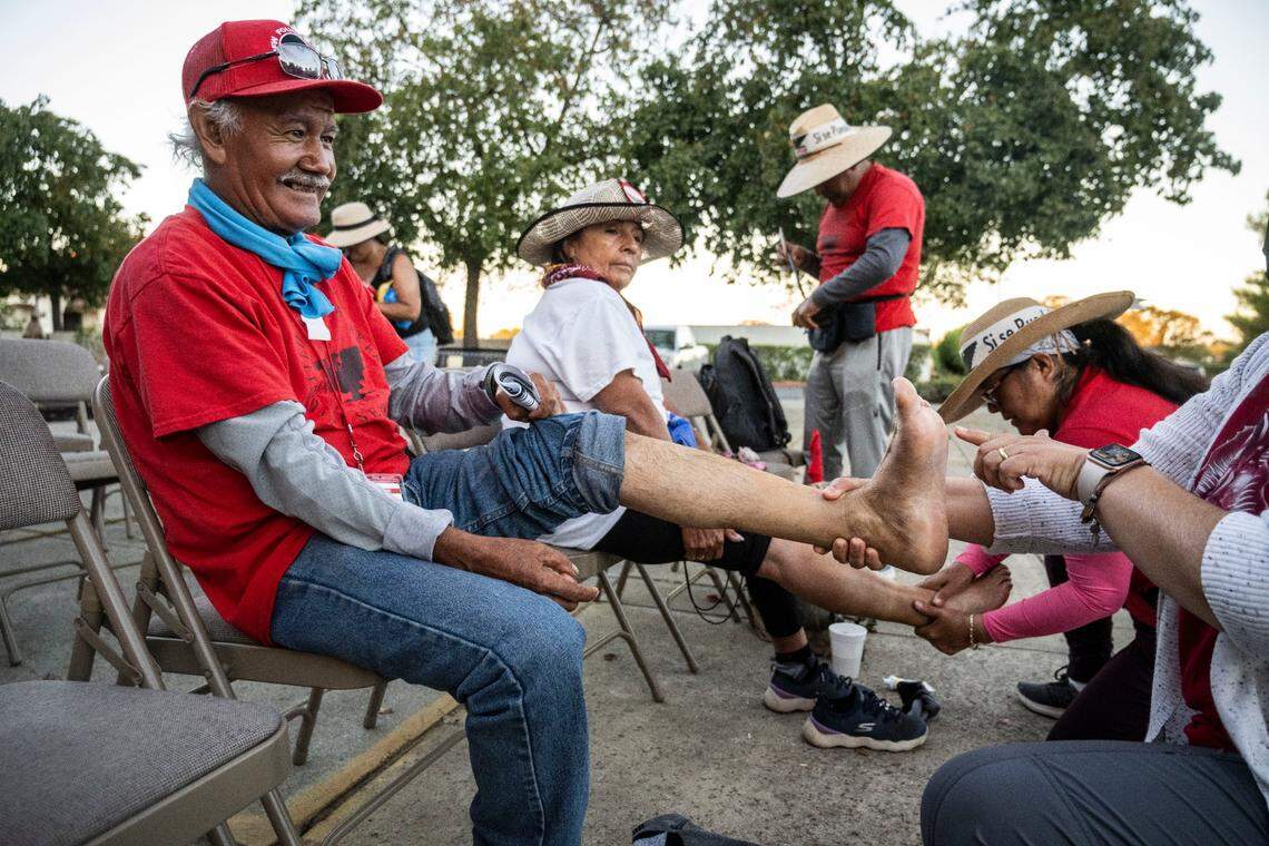 Asuncion Ponze, a UFW volunteer, has the blisters on his feet looked at after marching from Delano to Galt on Tuesday, Aug. 23, 2022. The 24 day 335 mile march will conclude on Friday with a large rally at the west steps of the capitol.