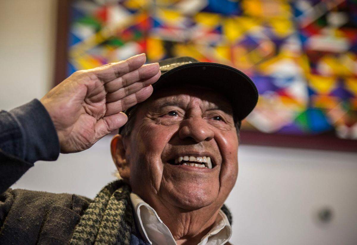Esteban Villa, a founding member of the Royal Chicano Air Force, poses for a picture for family after his group’s mural at the Golden 1 Center was dedicated in 2018.