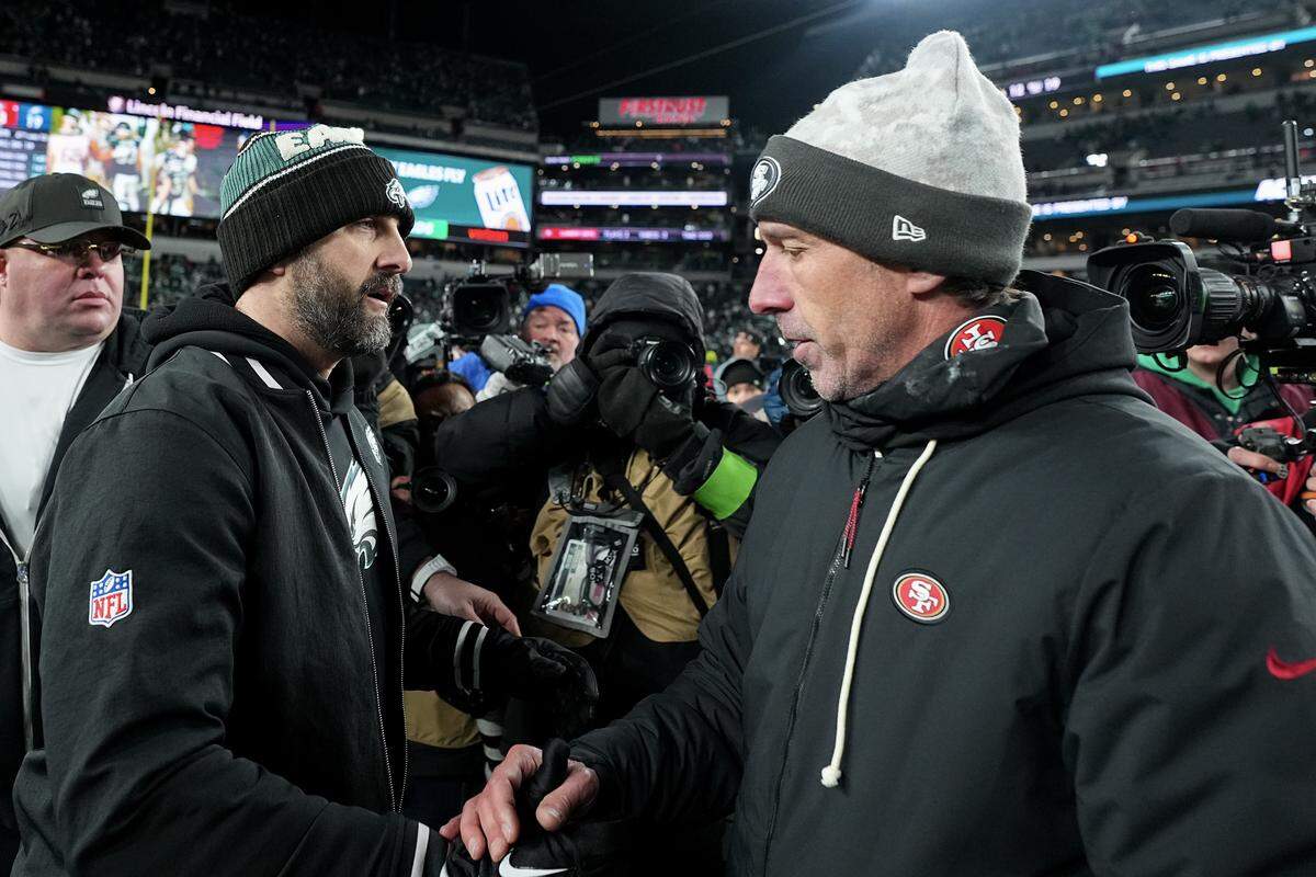 PHILADELPHIA, PENNSYLVANIA - JANUARY 11: Head coach Nick Sirianni of the Philadelphia Eagles and head coach Kyle Shanahan of the San Francisco 49ers shake hands after San Francisco's 23-19 win in the NFC Wild Card Playoff game at Lincoln Financial Field on January 11, 2026 in Philadelphia, Pennsylvania. (Photo by Mitchell Leff/Getty Images)