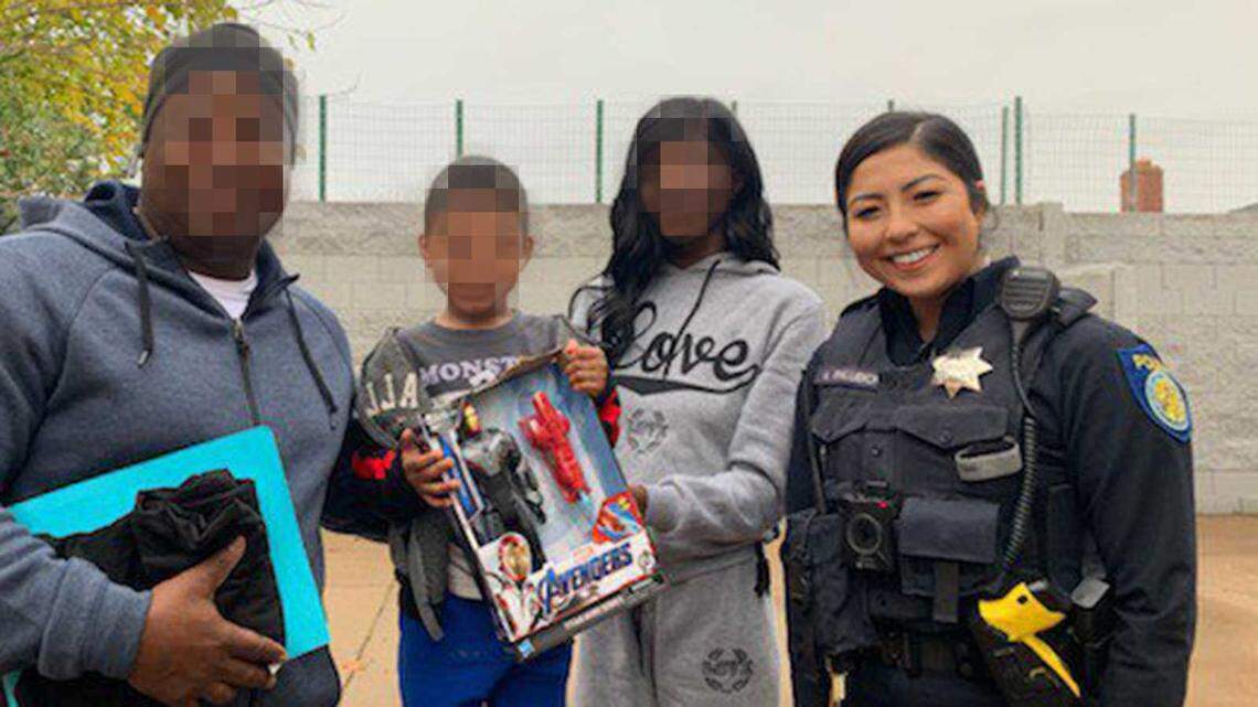 Sacramento Police Officer Alexa Palubicki is seen in a social media post by the department on Dec. 15, 2019, during a call for service where officers provided a family with Christmas gifts. Palubicki was arrested Thursday, May 6, 2021, following a 10-month investigation over a traffic stop. The Sacramento County District Attorney’s Office has filed charges against Palubicki for falsifying a police report.