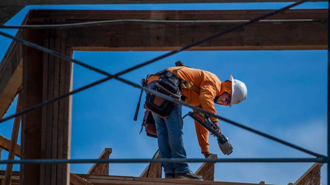 A worker frames a building during construction of Mirasol Village, a mixed income project that replaces the former Dos Rios public housing complex, is underway on Wednesday, Oct. 6, 2021, north of downtown Sacramento in the River District. The city’s plan to build affordable housing is aimed at curbing evictions and homelessness.