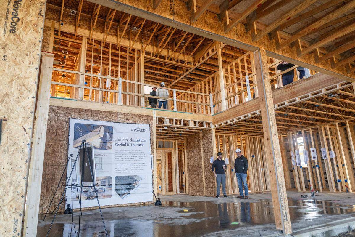 Visitors tour one of the homes built by Japanese homebuilder Sekisui House at the Shawood development in Folsom on Monday. The home is built with laminated wood and proprietary metal joints that create a stronger building, according to the company.