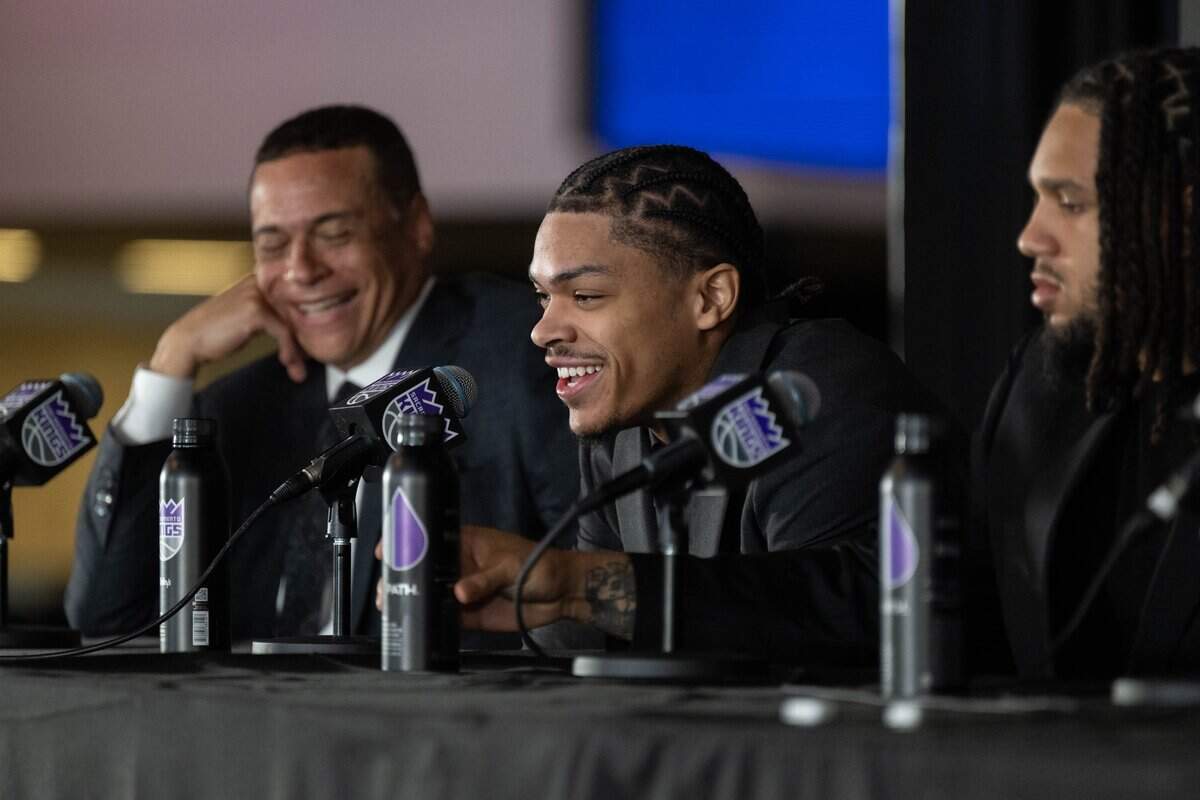 Sacramento Kings general manager Scott Perry, left, listens as 2026 NBA Draft selections Darius Acuff Jr., center, and Emanuel Sharp answer questions during an introductory news conference at Golden 1 Center in Sacramento on Monday.