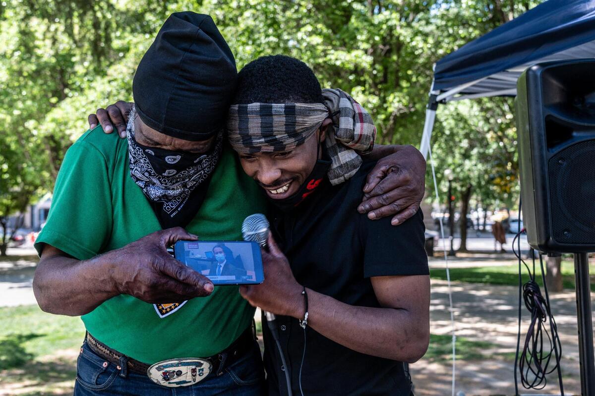 17. Stevante Clark, right, whose brother Stephon Clark was killed by Sacramento police in 2018, is embraced by his cousin Steven Ray Collins, left, at Cesar Chavez Plaza in Sacramento on Tuesday, April 20, 2021, as they listen live to the guilty verdict of Derek Chauvin for the murder of George Floyd.