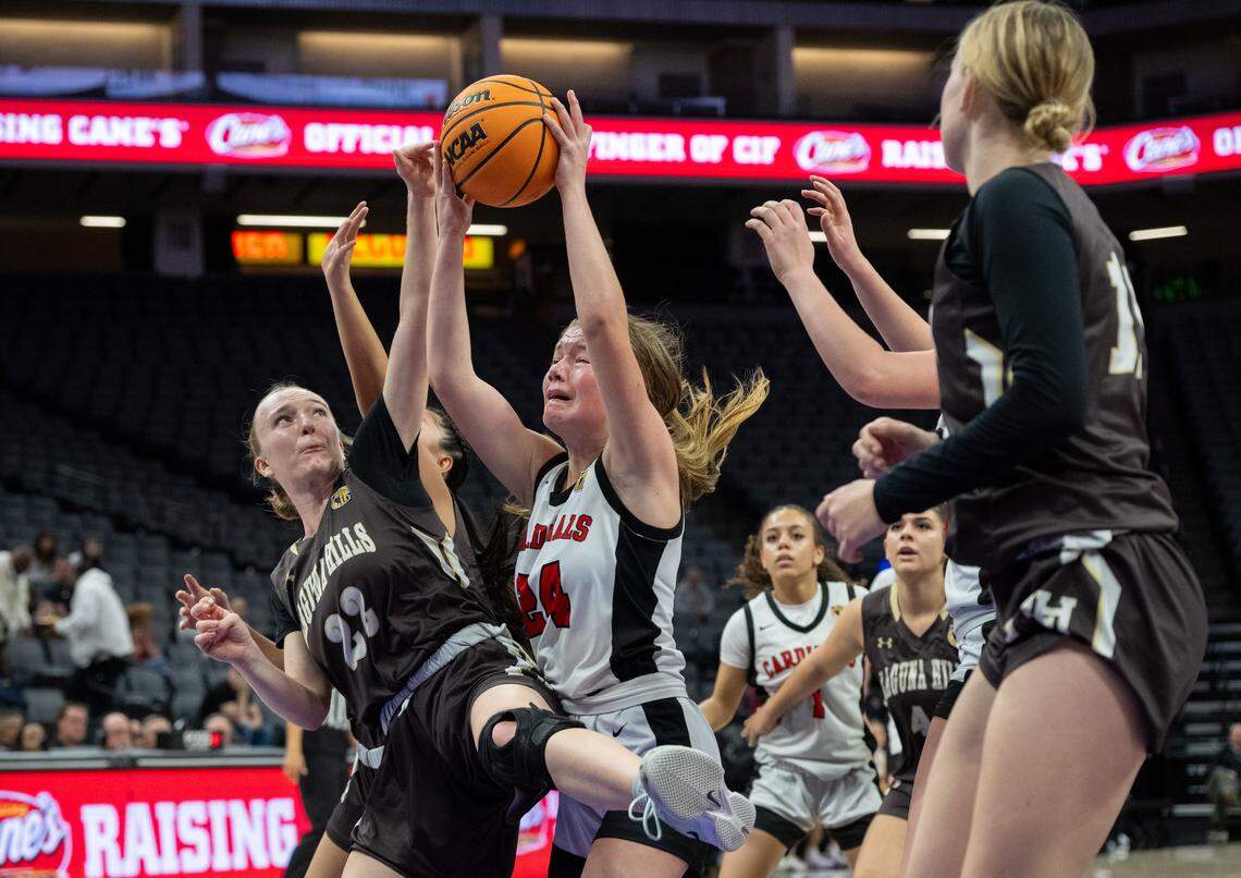 Woodland Christian’s Bailee Broward battles Laguna Hills’ Cameron McDermott (22) for a rebound during the 2026 CIF State Basketball Championship at the Golden 1 Center on Friday in Sacramento.