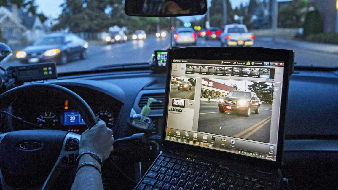 A police officer in Tacoma, Washington, monitors data from a car-mounted automatic license plater reader in 2014. A Sacramento County grand jury investigation into the use of license plate readers by local law enforcement, released Wednesday, June 26, 2024, accuses the Sheriff’s Office and Police Department of violating state law in its handling and oversight of data collected by such readers.