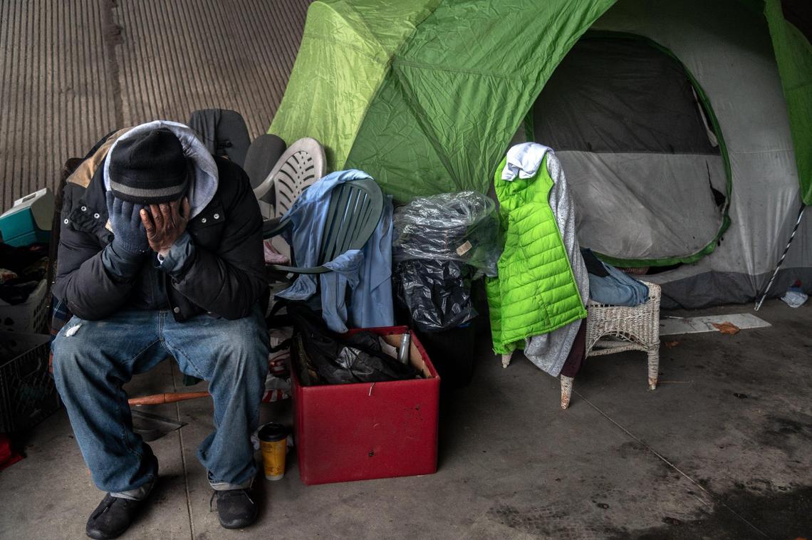 Harold Carter, 52, mourns the death of his partner Karen Hunter, 57, Thursday, Jan. 28, 2021, at the tent where she died on Tuesday night in a homeless encampment under the W-X freeway on 26th Street in Sacramento during a severe storm. “That was my wife, she was my girlfriend, she was my best friend, that was my big sister, she was everything to me,” said Carter.