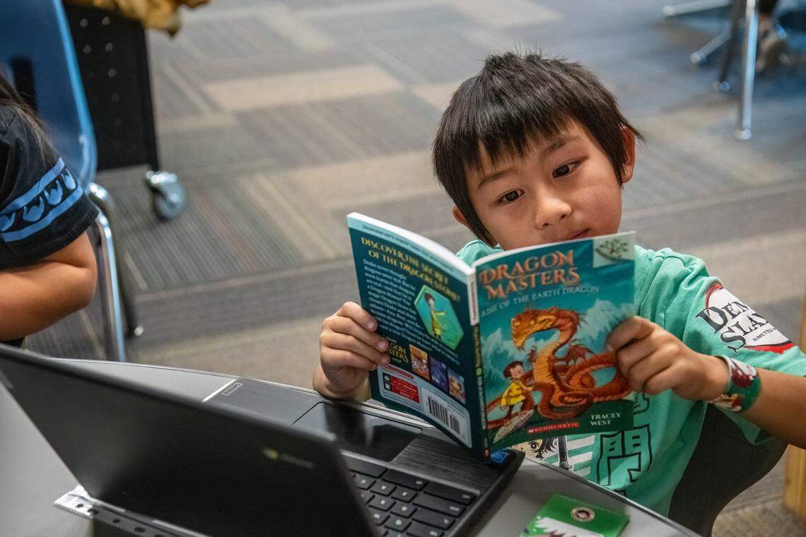 During a break with his in-house tutor, Levi intently reads through one of the many books available to him at the Yolo Kids Read program at Bell Avenue Elementary earlier this month.