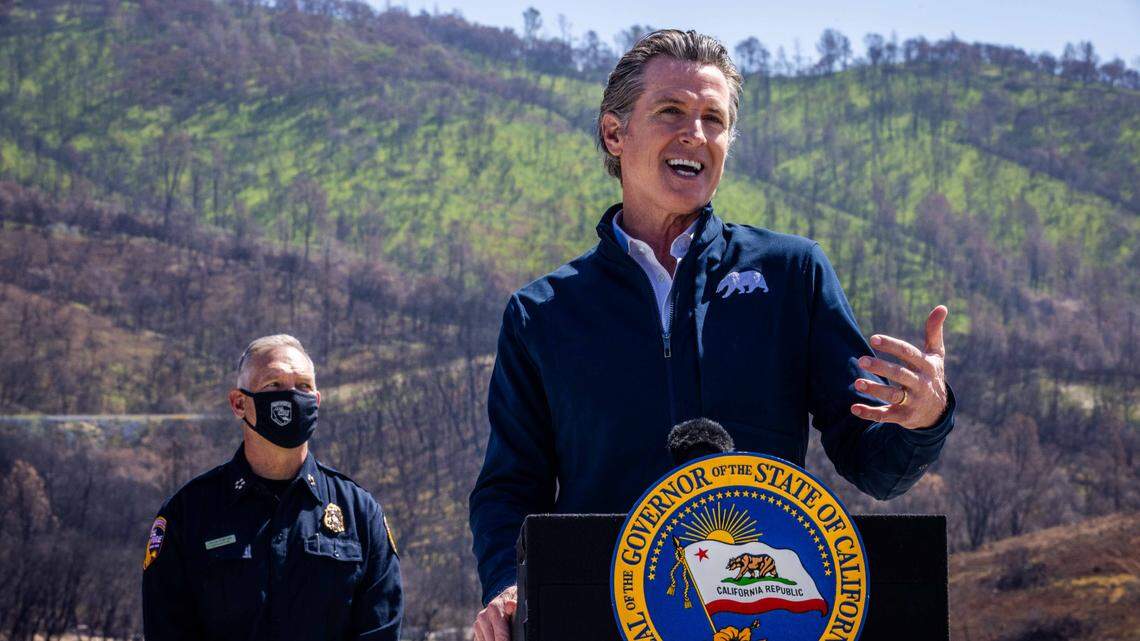 California Gov. Gavin Newsom speaks at a press conference, standing in front of a hillside burned by the North Complex Fire at the Loafer Creek State Recreation Area near Oroville, on Tuesday, April 13, 2021, the day he formally approved the spending more than a half billion dollars on wildfire prevention.