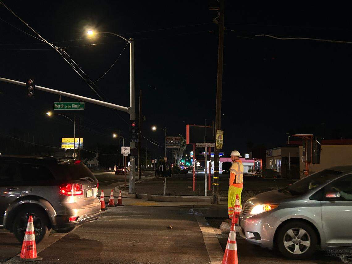 A worker guides traffic from the median near the Martin Luther King Jr. Boulevard exit on Highway 99. It’s a daily reality for construction crews to work in close proximity to fast-moving cars.