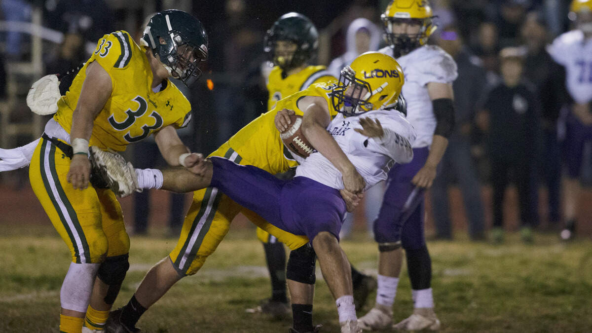 Paradise’s Josh Alvies, left, tackles Live Oak High School’s Nick Gomes during the second half of their playoff game last fall. The Northern Section schools could still play football this fall amid the coronavirus pandemic.