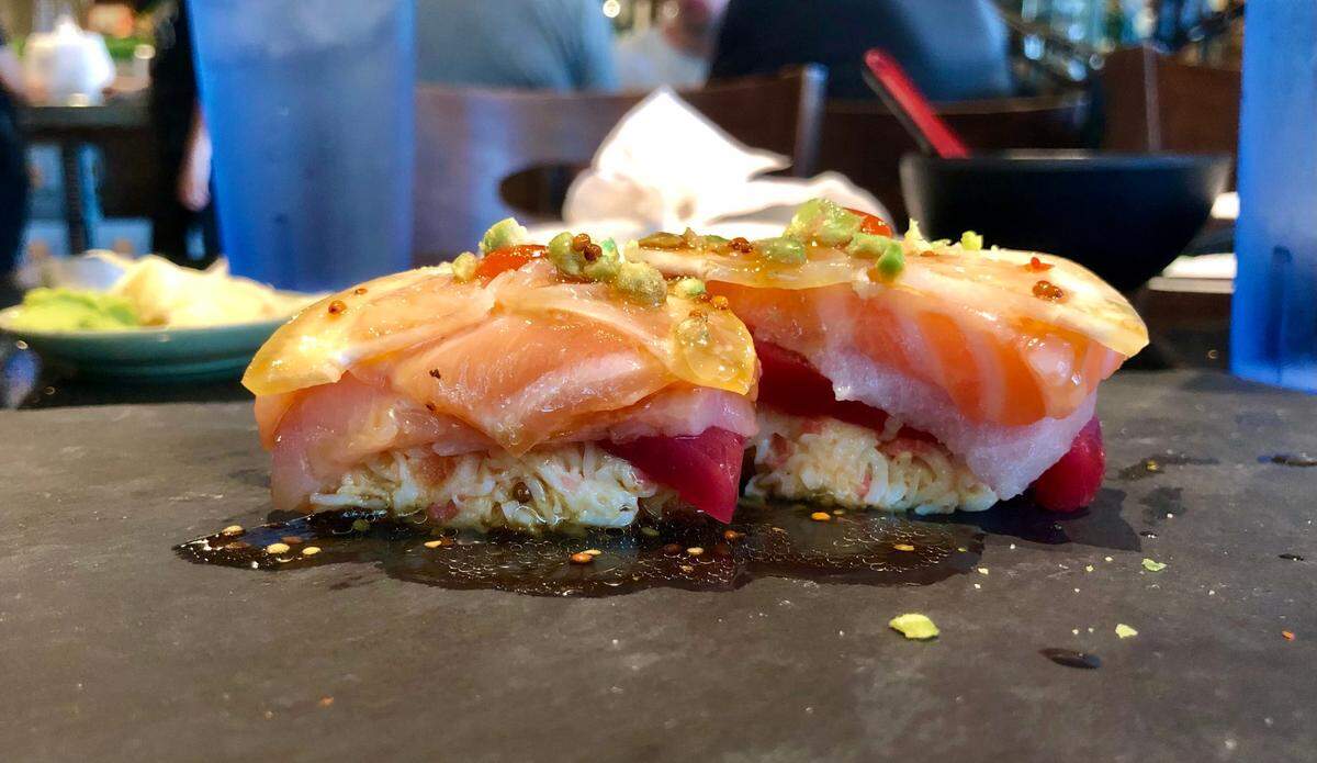 The Brodie Triple Stack at Tang’s Sushi piles tuna, salmon and hamachi sashimi over spicy crab, with wasabi peas and mustard ponzo sauce on top.
