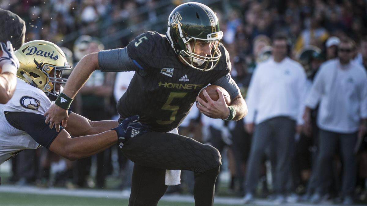 Sacramento State quarterback Kevin Thomson (5) runs for a touchdown against UC Davis in the Causeway Classic on Nov. 18, 2017 at Hornet Stadium