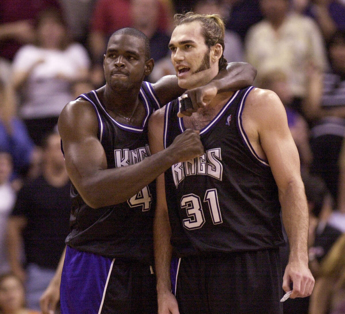 The Sacramento Kings’ Chris Webber gives teammate Scot Pollard a thump on the chest as their team secured a Game 4 first-round playoff win over the Phoenix Suns  in 2001.
