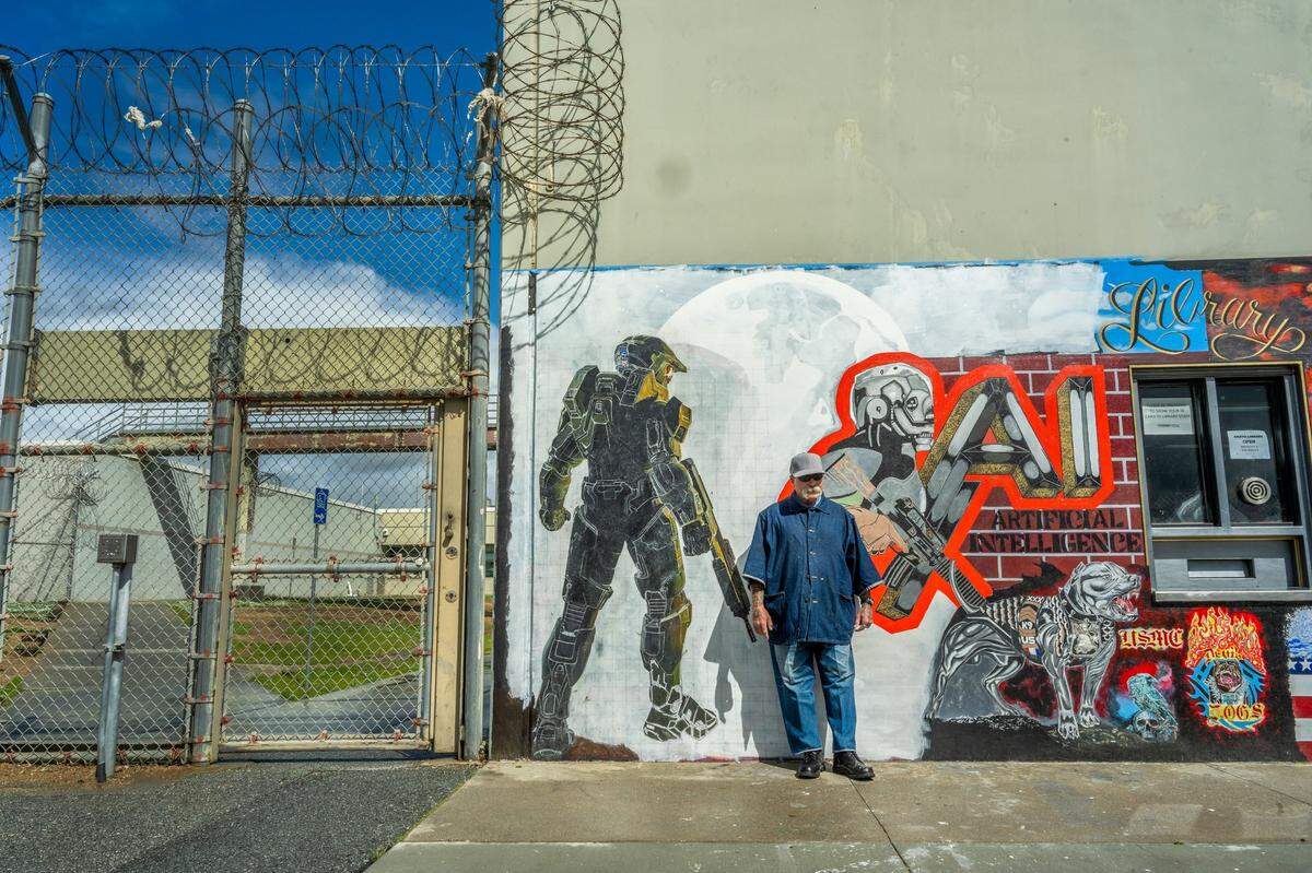 Inmate Dale Bretches, 69, said he comes at night, climbs on a ladder, and paints as he stood near one of the murals he worked on at Salinas Valley State Prison in March. “Most nights I paint and when I go back to my cell I feel so relaxed,” said Bretches who was convicted of second-degree murder in 1979.