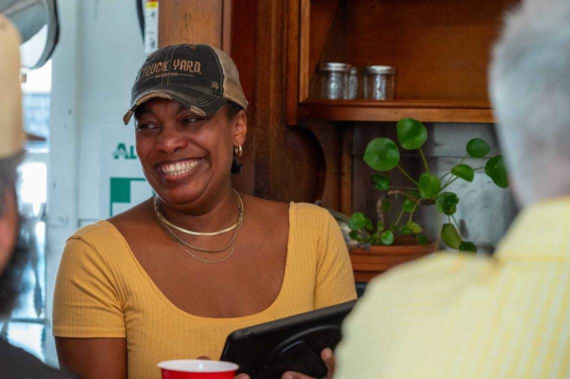 Owner N’Gina Guyton takes customer orders at Jim-Denny’s closing day in Sacramento on July 2, 2025.