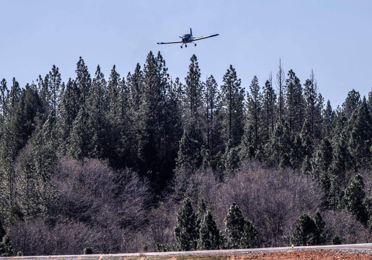 Eric Meyer, of Jackson, maneuvers over tall trees as he approaches the runway at the Georgetown Airport in El Dorado County on Friday. “Some of the trees should be removed,” said Meyer, who has had to go to a different airport because he couldn’t land at night.
