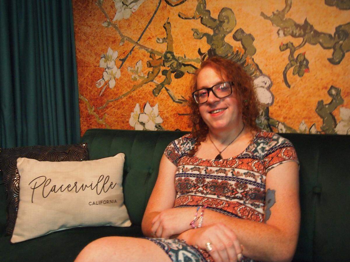 Rebecca Barry rests in the back of the Green Room Social Club before hosting her monthly queer community social.