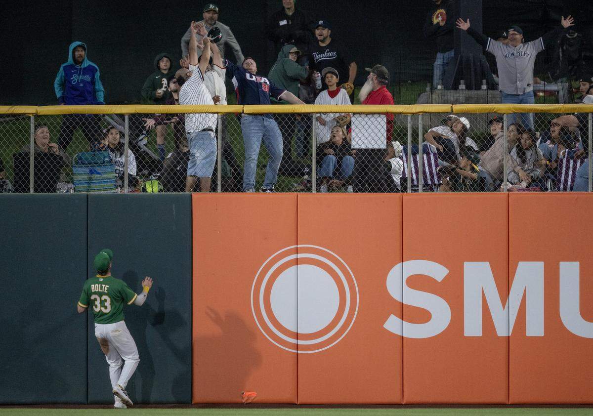 Athletics center fielder Henry Bolte watches the ball hit by New York Yankees first baseman Ben Rice land in the right center field grass for a home run on Friday at Sutter Health Park in West Sacramento.